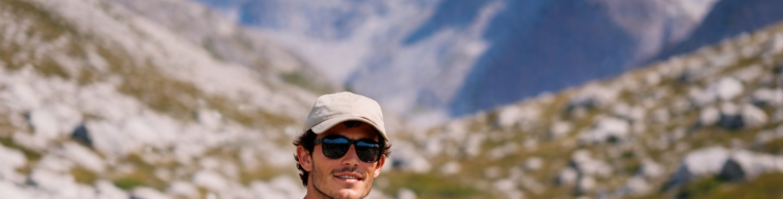 Man with a backpack standing in a mountainous landscape