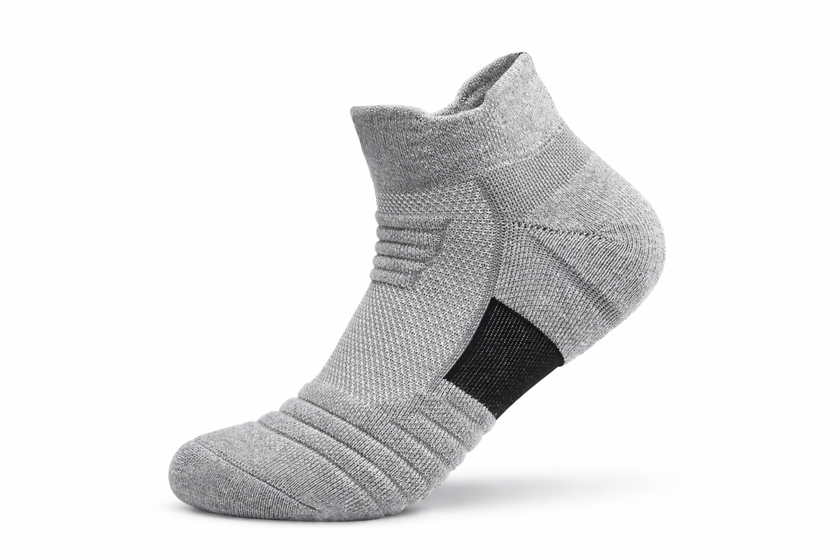 Gray ankle sock with a black patch on a white background